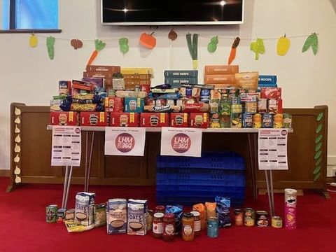 Food donations for the harvest festival piled up on a table in the church.